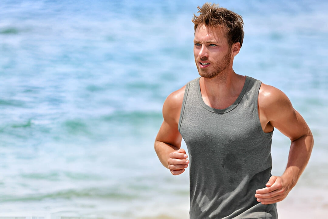 handsome young male athlete wearing grey tank top